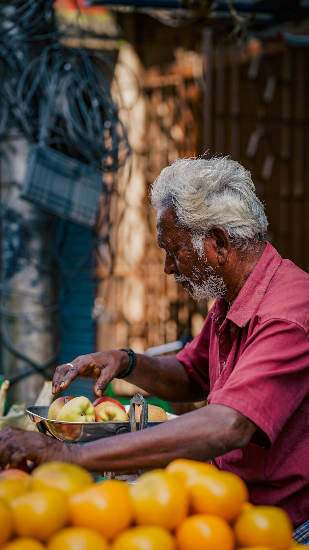 Portrait of a street market vendor arranging fruit