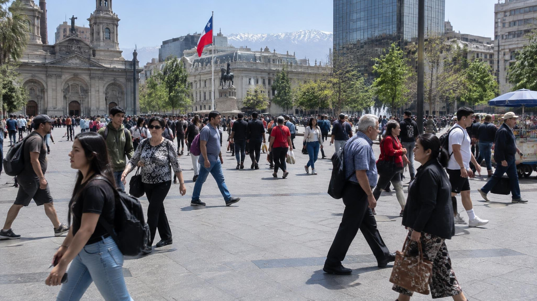 Crowd of people crossing a busy plaza in a South American city