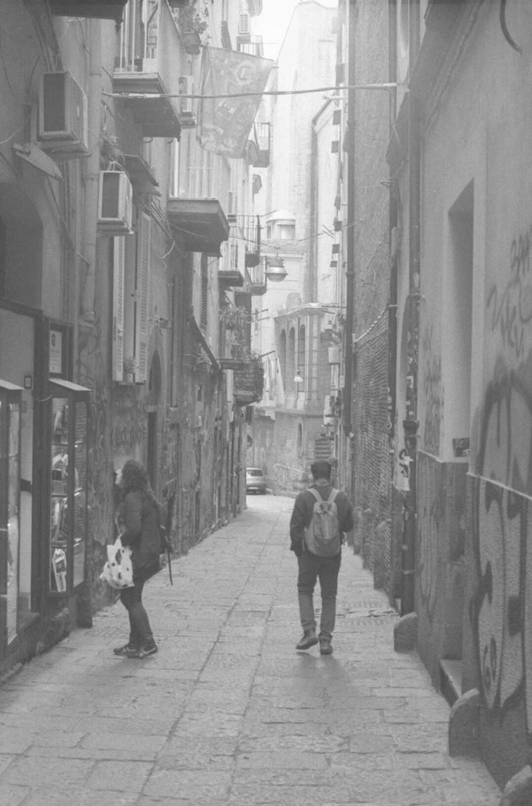 Children playing soccer on a narrow city street