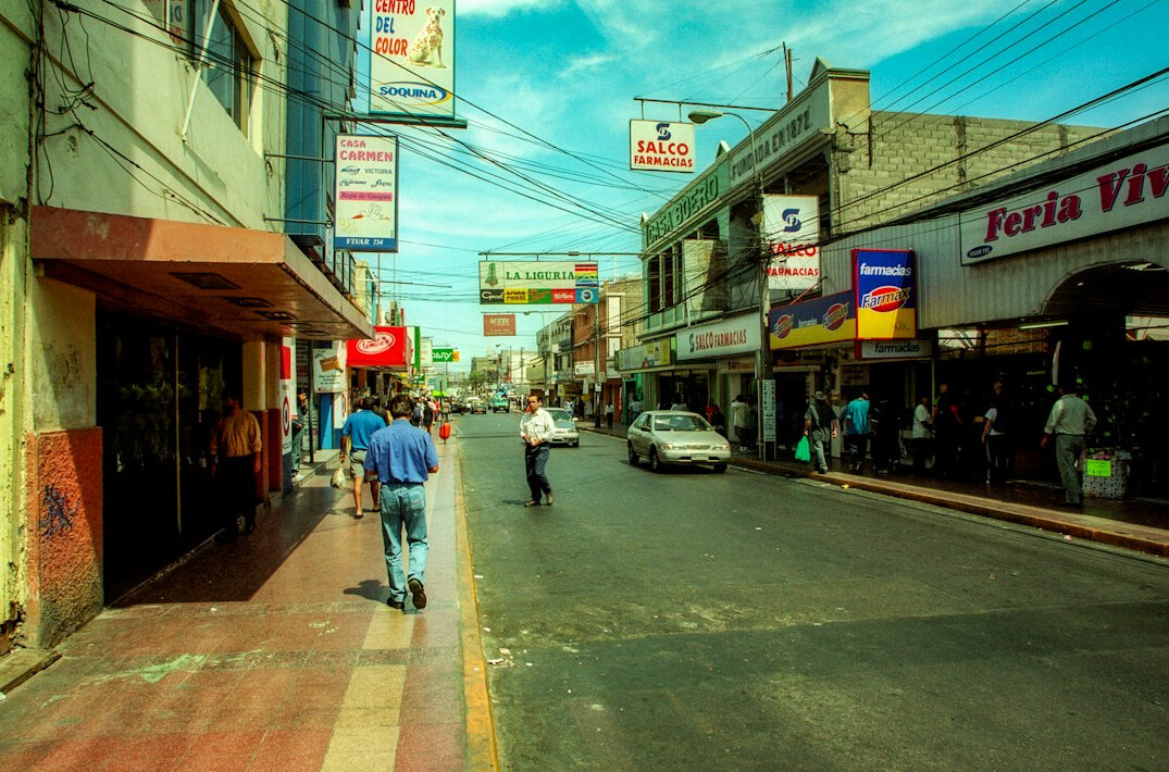 Wide view of a historic city street with pedestrians in Chile